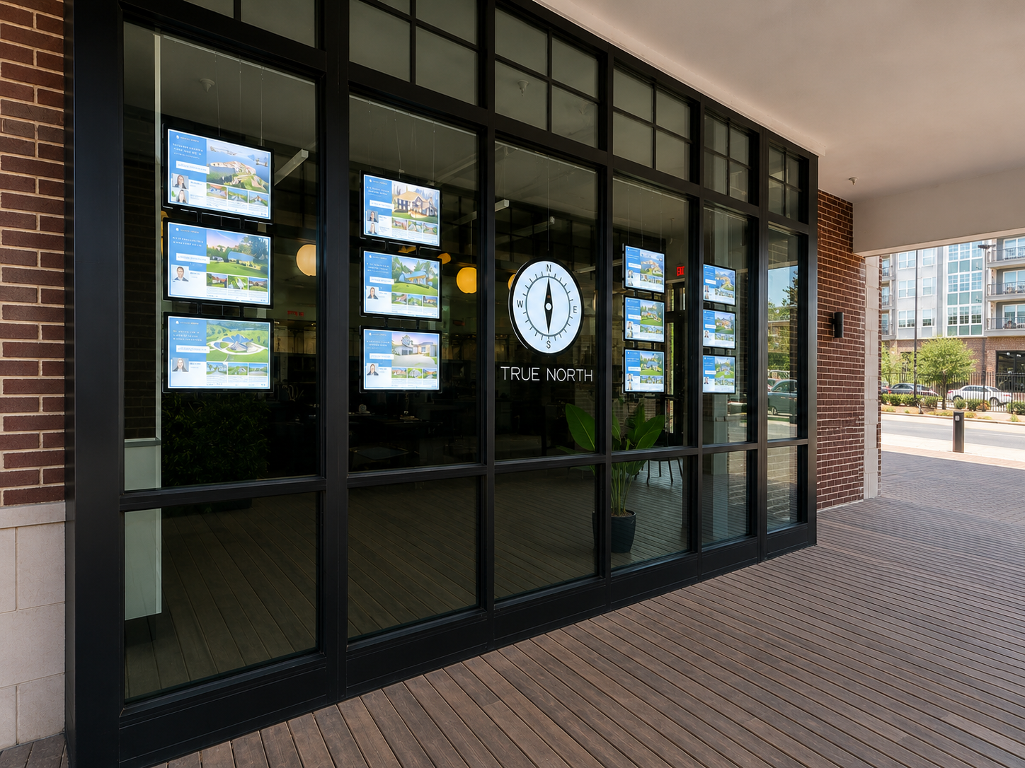 True North Realty Hickory storefront — illuminated listing displays and compass mark